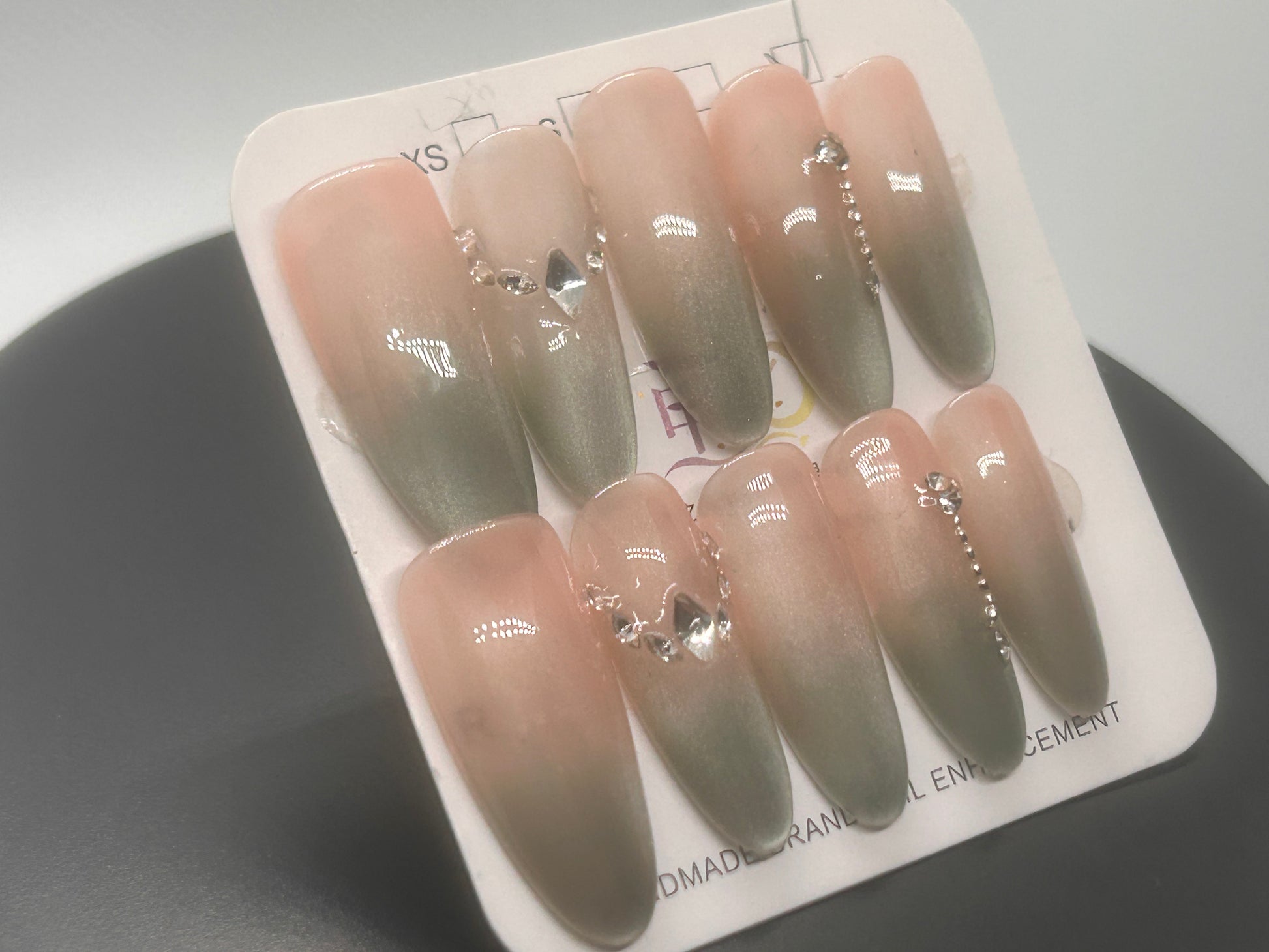 These luxury press-ons blend nude and sage ombré with silver crystal accents for a soft but regal finish.